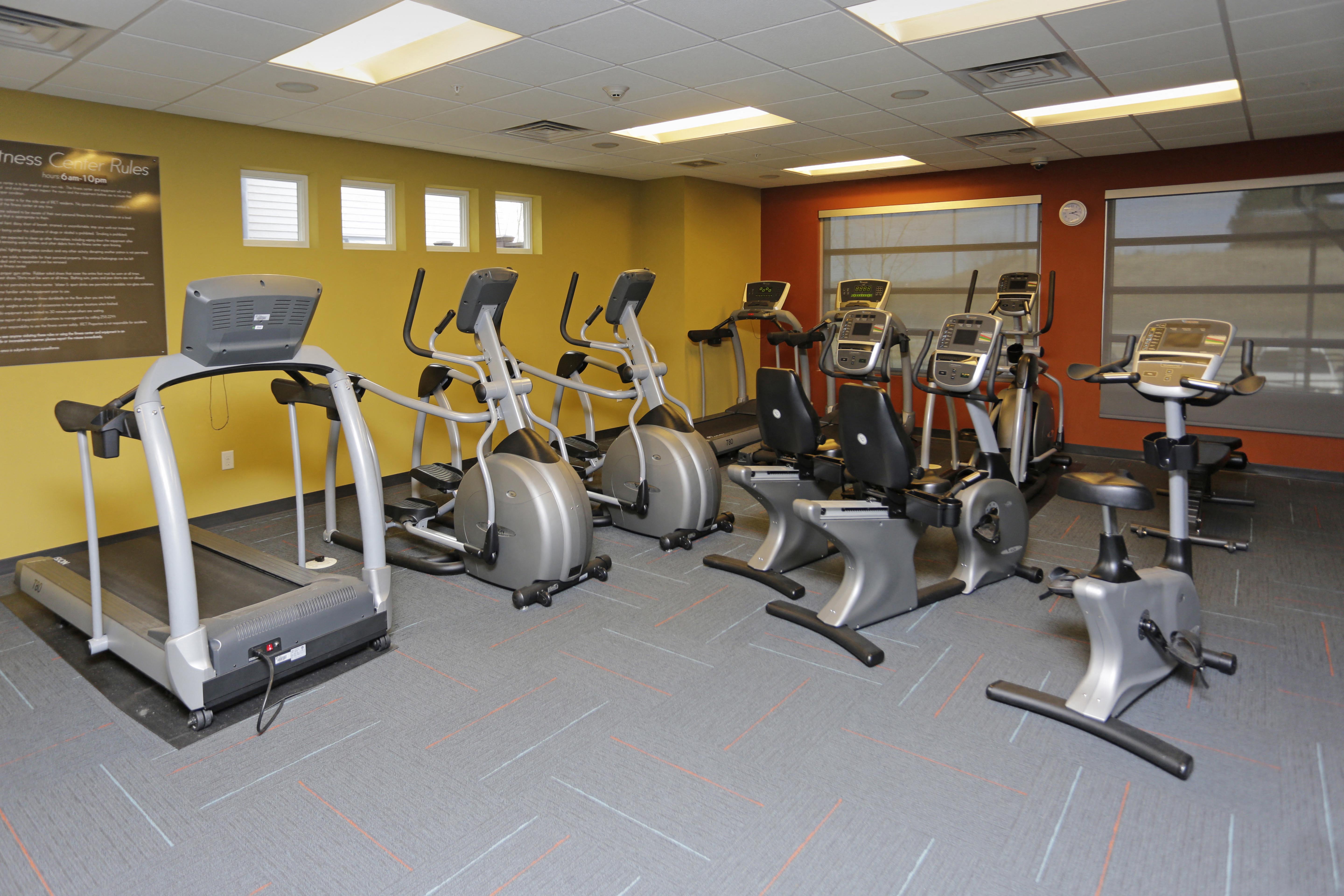 Angled view of the fitness center showcasing the cardio and strength equipment.